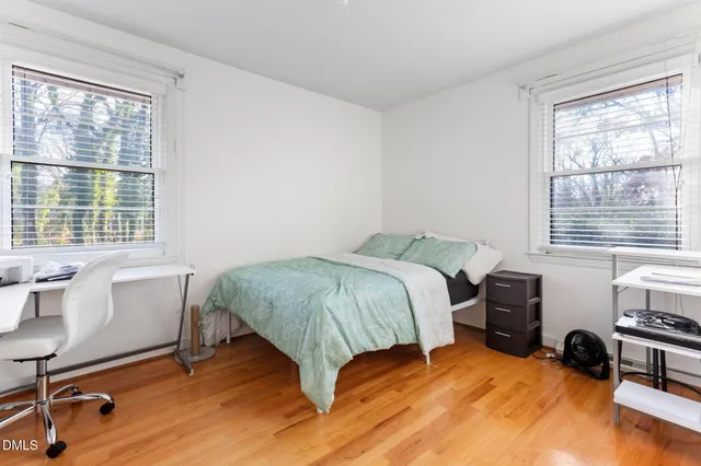 a spacious bedroom with a bed and a large window