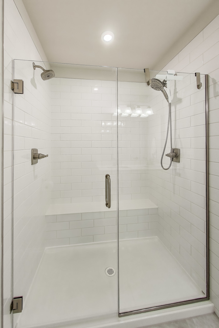 205 Dawson Drive Mount Prospect, IL 60056 - Photo 18 of 28 a bathroom with a glass shower door