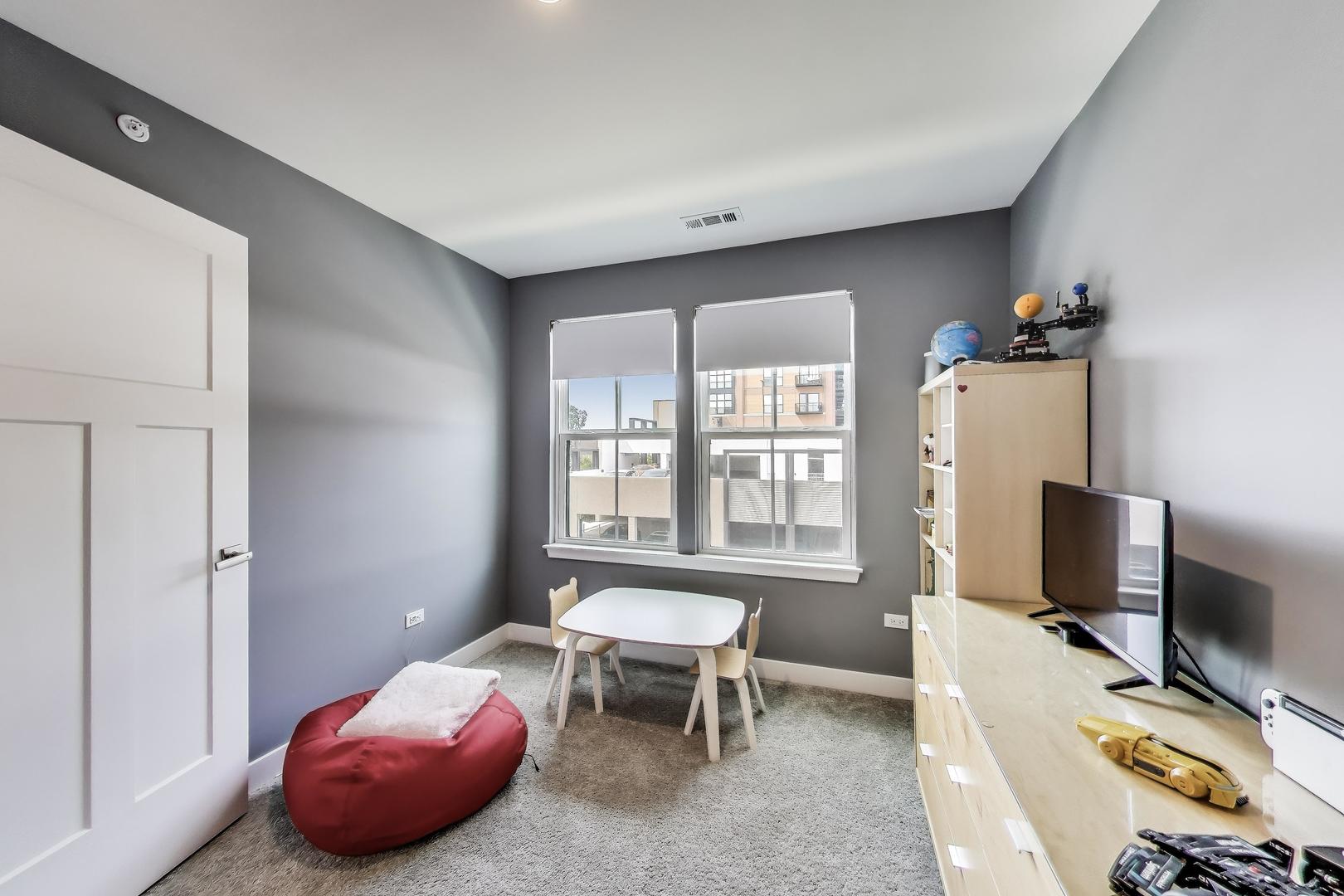 205 Dawson Drive Mount Prospect, IL 60056 - Photo 19 of 28 a bedroom with furniture and a flat screen tv