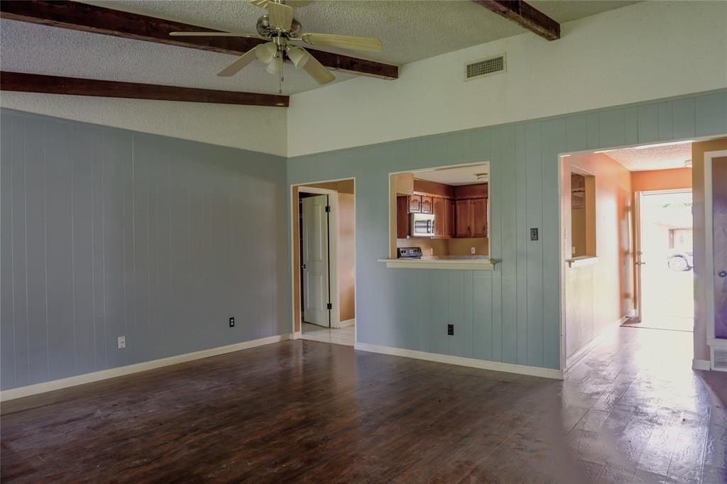 300 Coury Road Everman, TX 76140 - Photo 5 of 29 en empty room with window and wooden floor