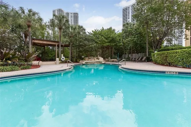 a view of a lake with boats and trees in the background