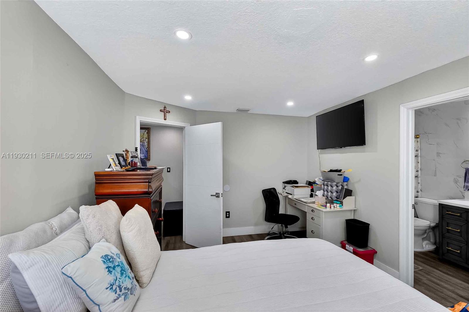 20810 Southwest 125th Court Road Miami, FL 33177 - Photo 21 of 52 a bedroom with a bed and a flat screen tv