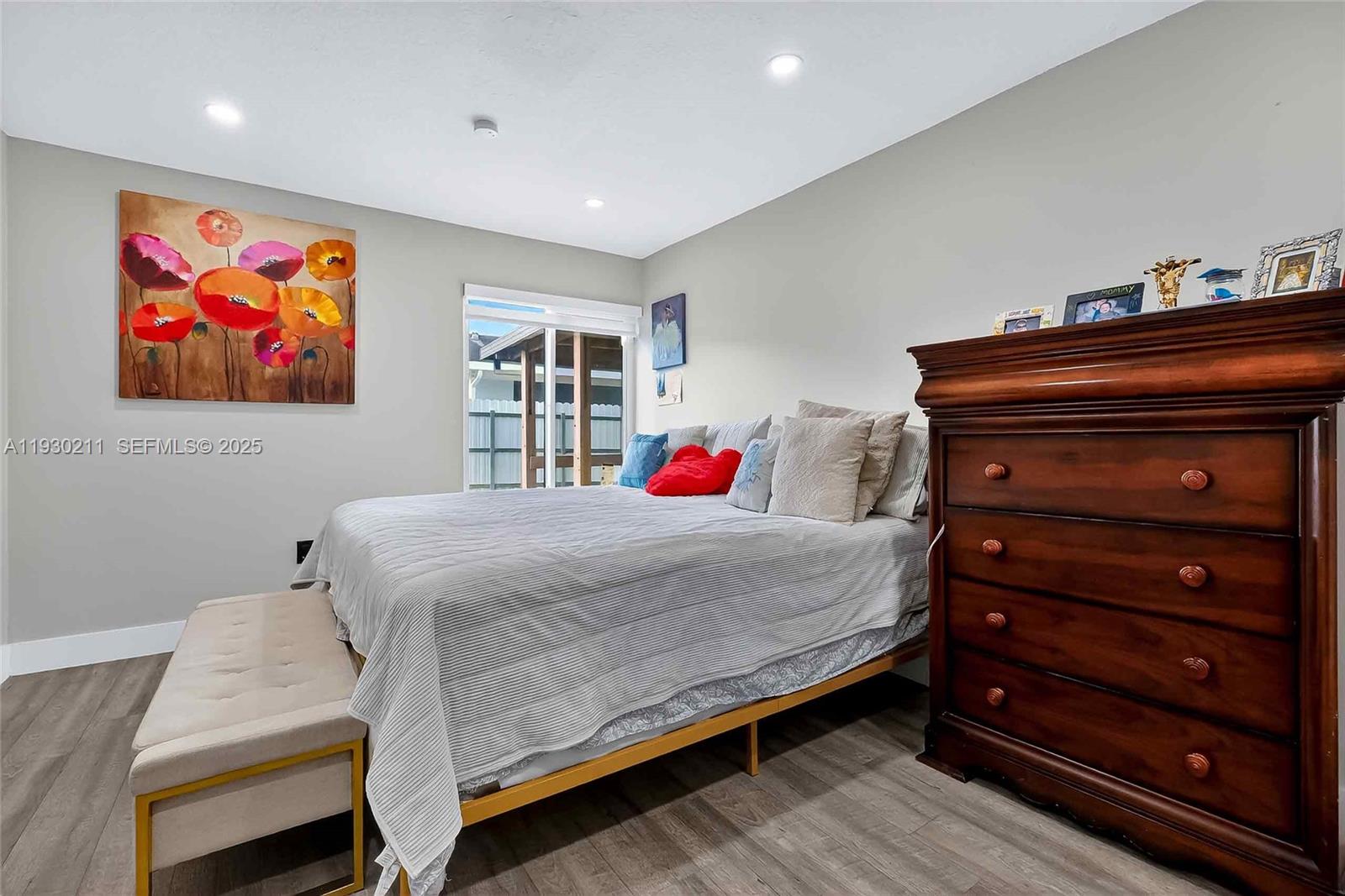 20810 Southwest 125th Court Road Miami, FL 33177 - Photo 22 of 52 a bedroom with a bed and a chandelier