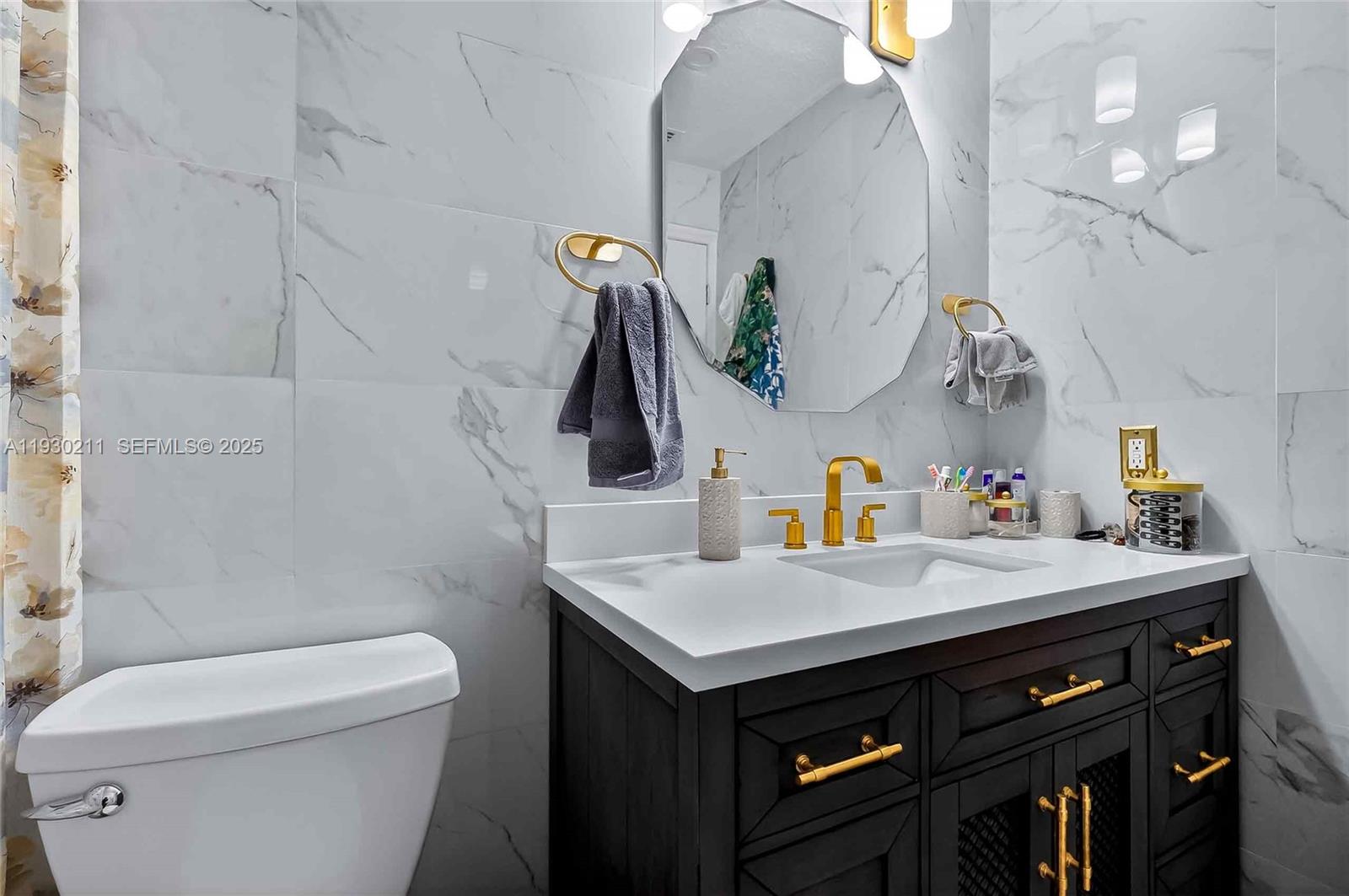 20810 Southwest 125th Court Road Miami, FL 33177 - Photo 24 of 52 a bathroom with a sink vanity and toilet