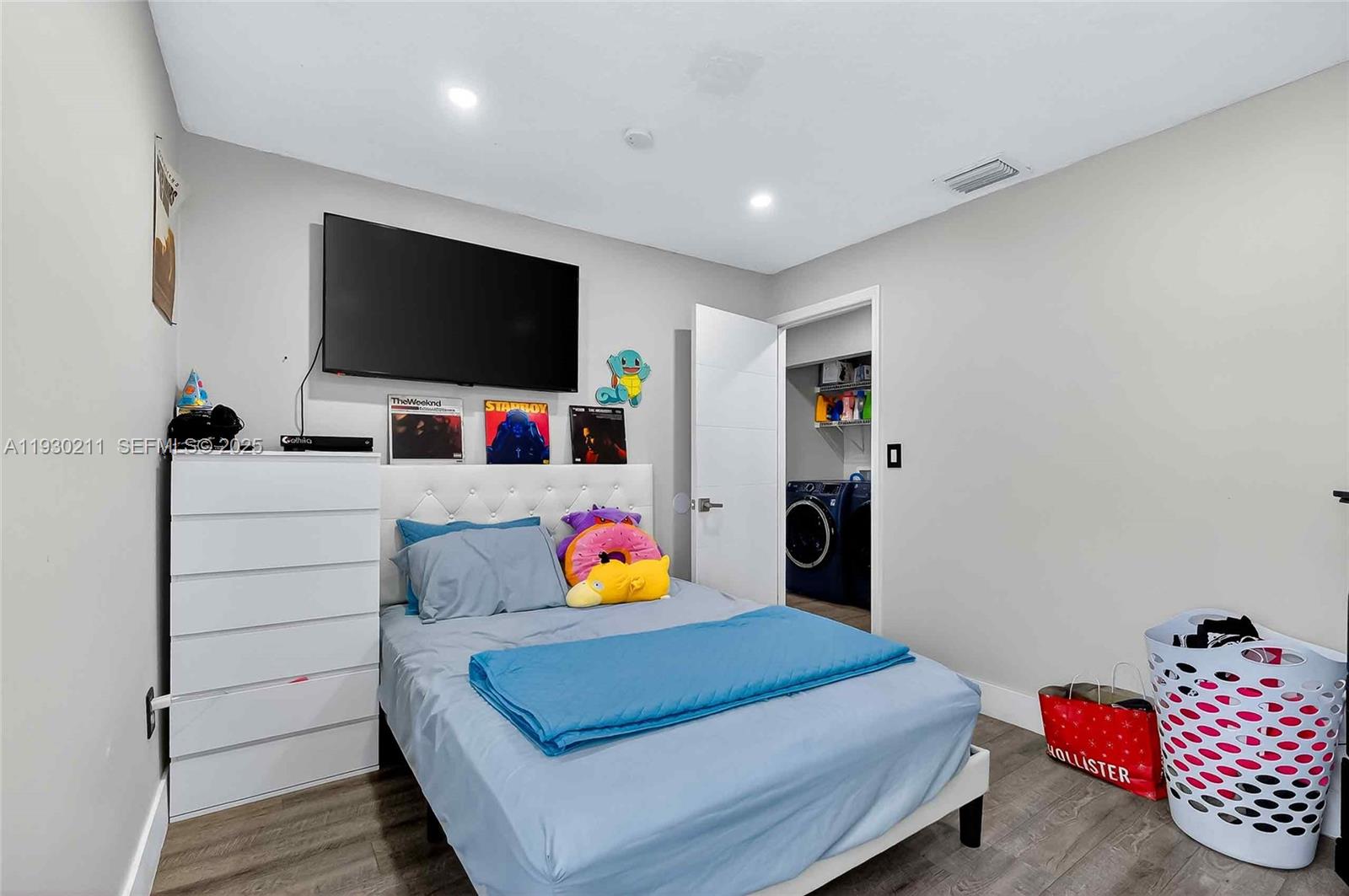 20810 Southwest 125th Court Road Miami, FL 33177 - Photo 27 of 52 a living room with furniture and a flat screen tv
