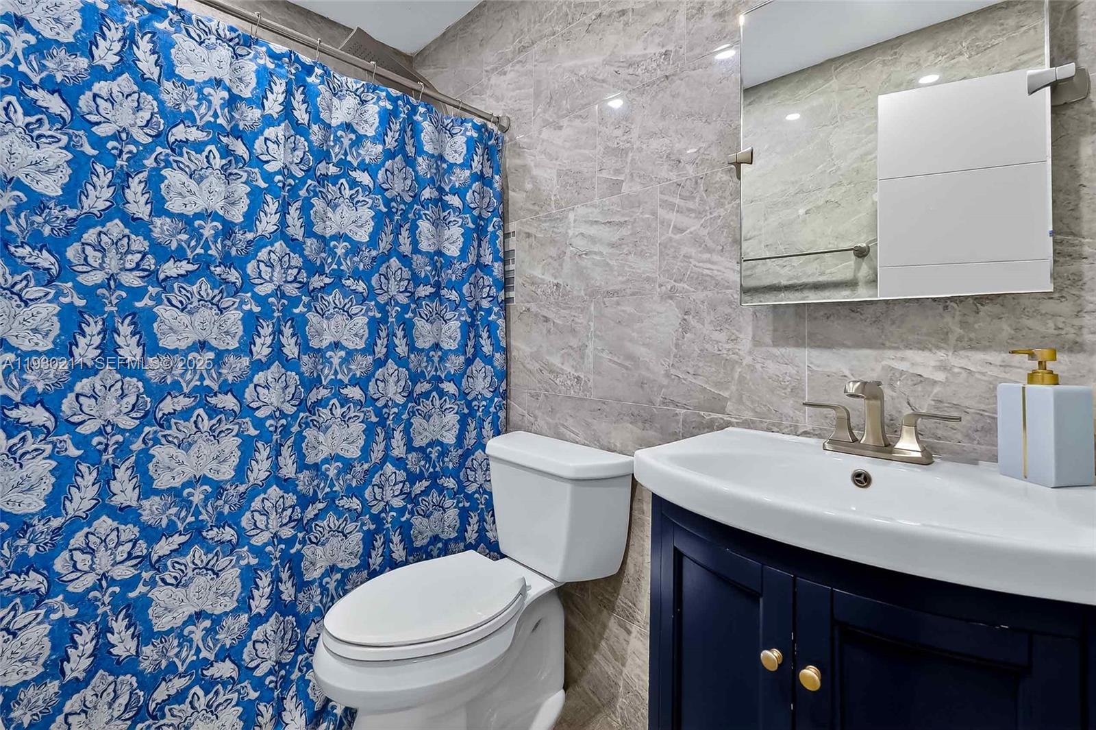 20810 Southwest 125th Court Road Miami, FL 33177 - Photo 28 of 52 a bathroom with a sink a toilet and a mirror