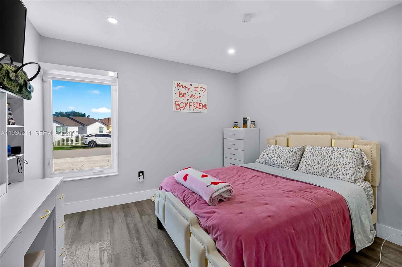 20810 Southwest 125th Court Road Miami, FL 33177 - Photo 30 of 52 a bed sitting in a bedroom next to a window