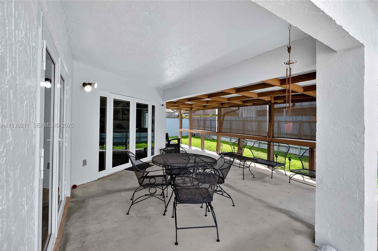 20810 Southwest 125th Court Road Miami, FL 33177 - Photo 36 of 52 a dining room with furniture and a floor to ceiling window