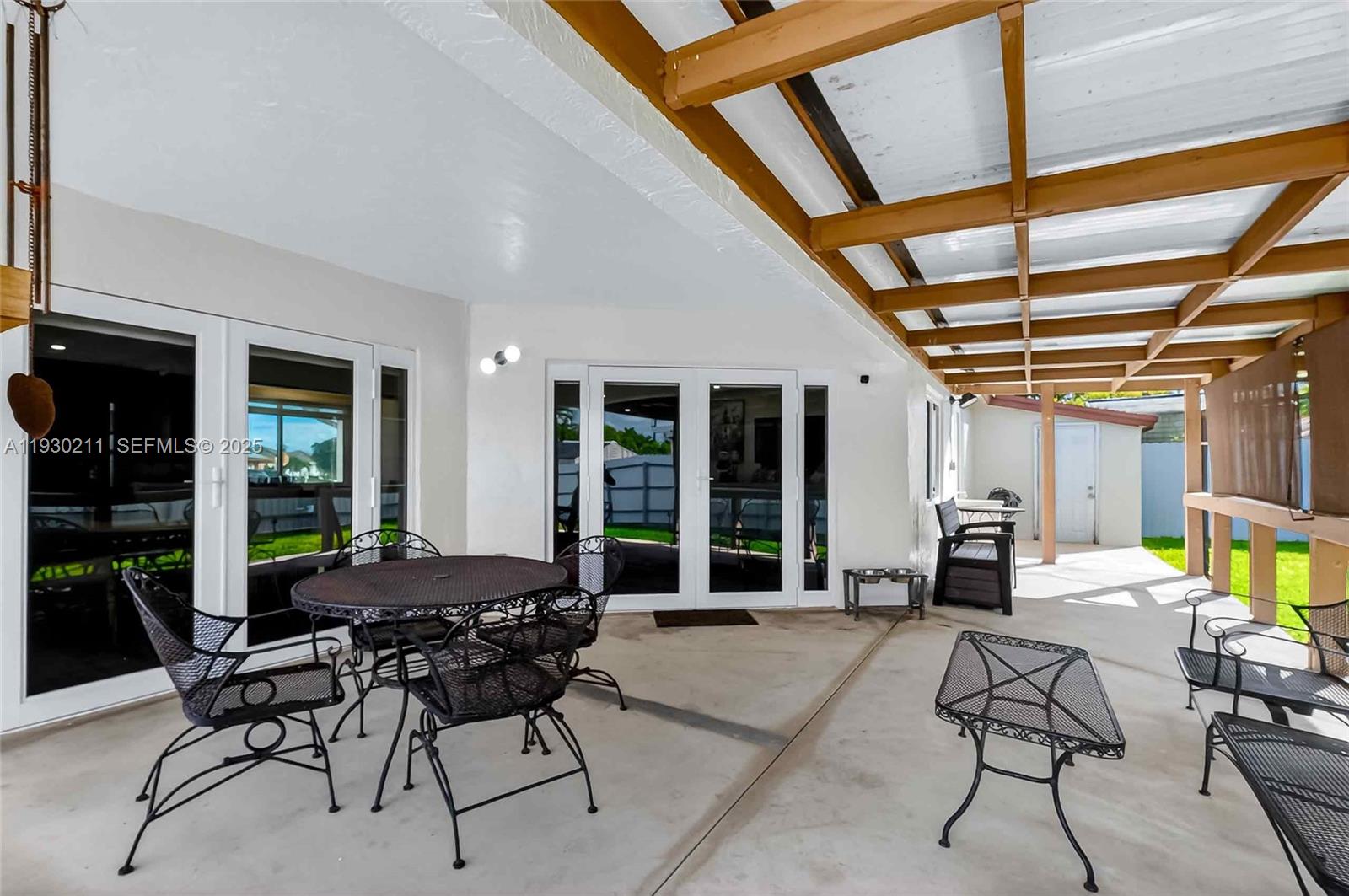 20810 Southwest 125th Court Road Miami, FL 33177 - Photo 37 of 52 a living room with furniture and large windows
