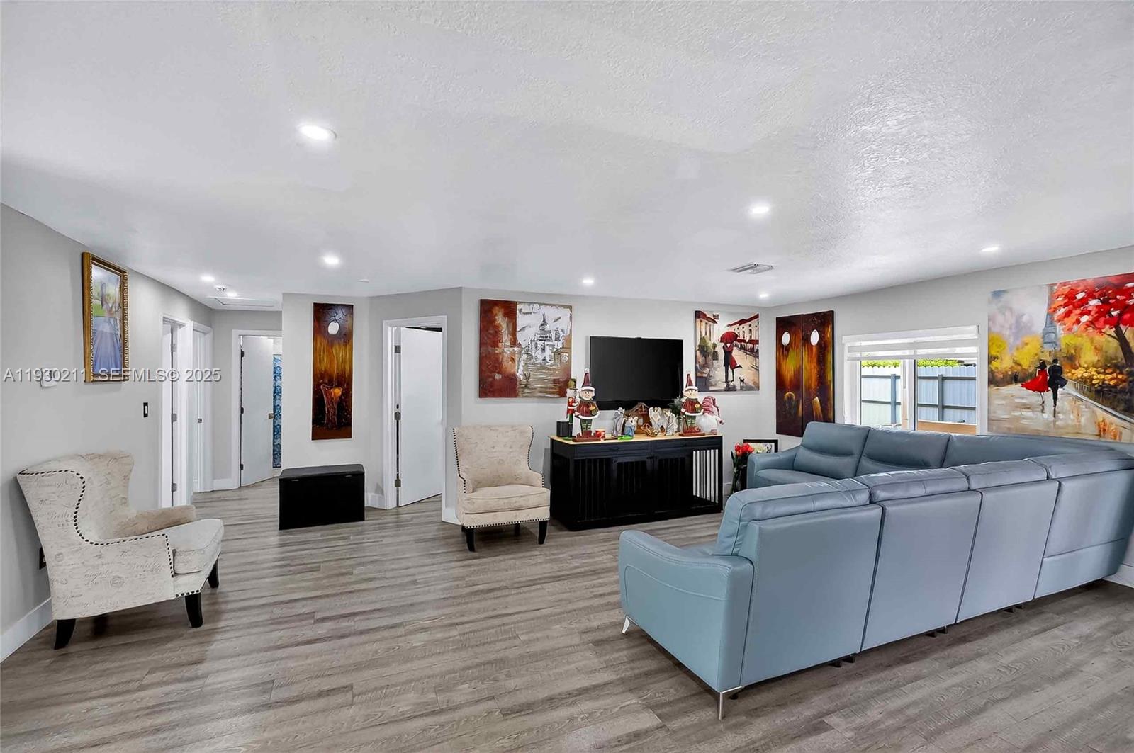 20810 Southwest 125th Court Road Miami, FL 33177 - Photo 9 of 52 a living room with furniture and a flat screen tv