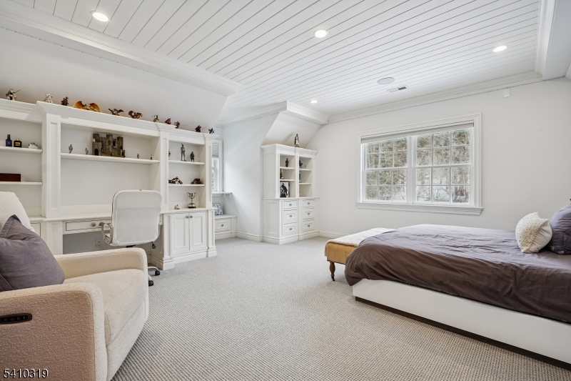 91 Mosle Road Peapack-Gladstone, NJ 07931 - Photo 28 of 37 a spacious bedroom with a bed and a couch