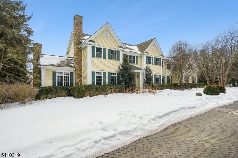 91 Mosle Road Peapack-Gladstone, NJ 07931 - Photo 3 of 37 a front view of a house with a yard covered in snow