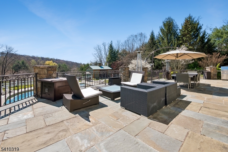 91 Mosle Road Peapack-Gladstone, NJ 07931 - Photo 37 of 49 a view of a patio with couches and a table and chairs