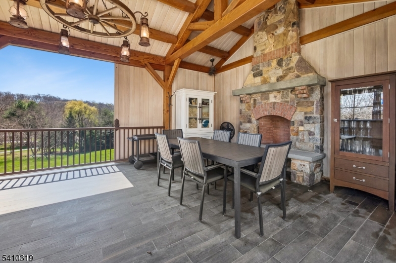 91 Mosle Road Peapack-Gladstone, NJ 07931 - Photo 44 of 49 a view of a patio with a table chairs and a backyard