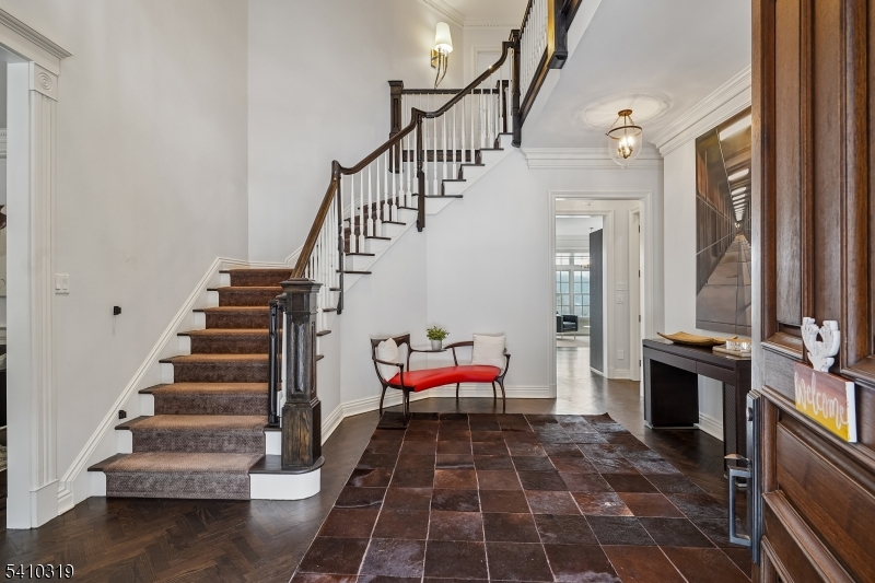 91 Mosle Road Peapack-Gladstone, NJ 07931 - Photo 6 of 37 a hallway with stairs and a rug
