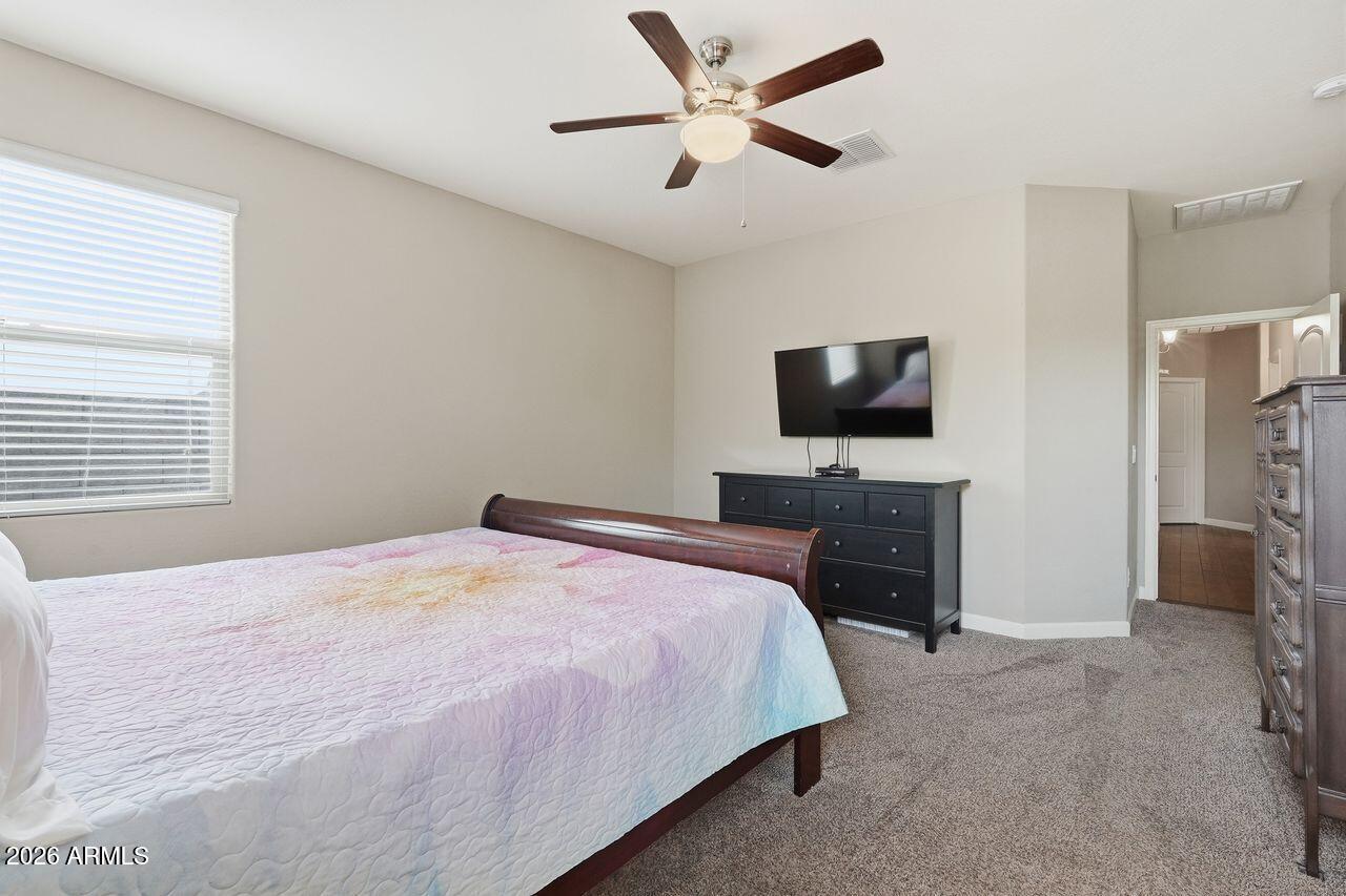 23602 West Ripple Road Buckeye, AZ 85326 - Photo 23 of 38 a bedroom with a bed and a flat screen tv