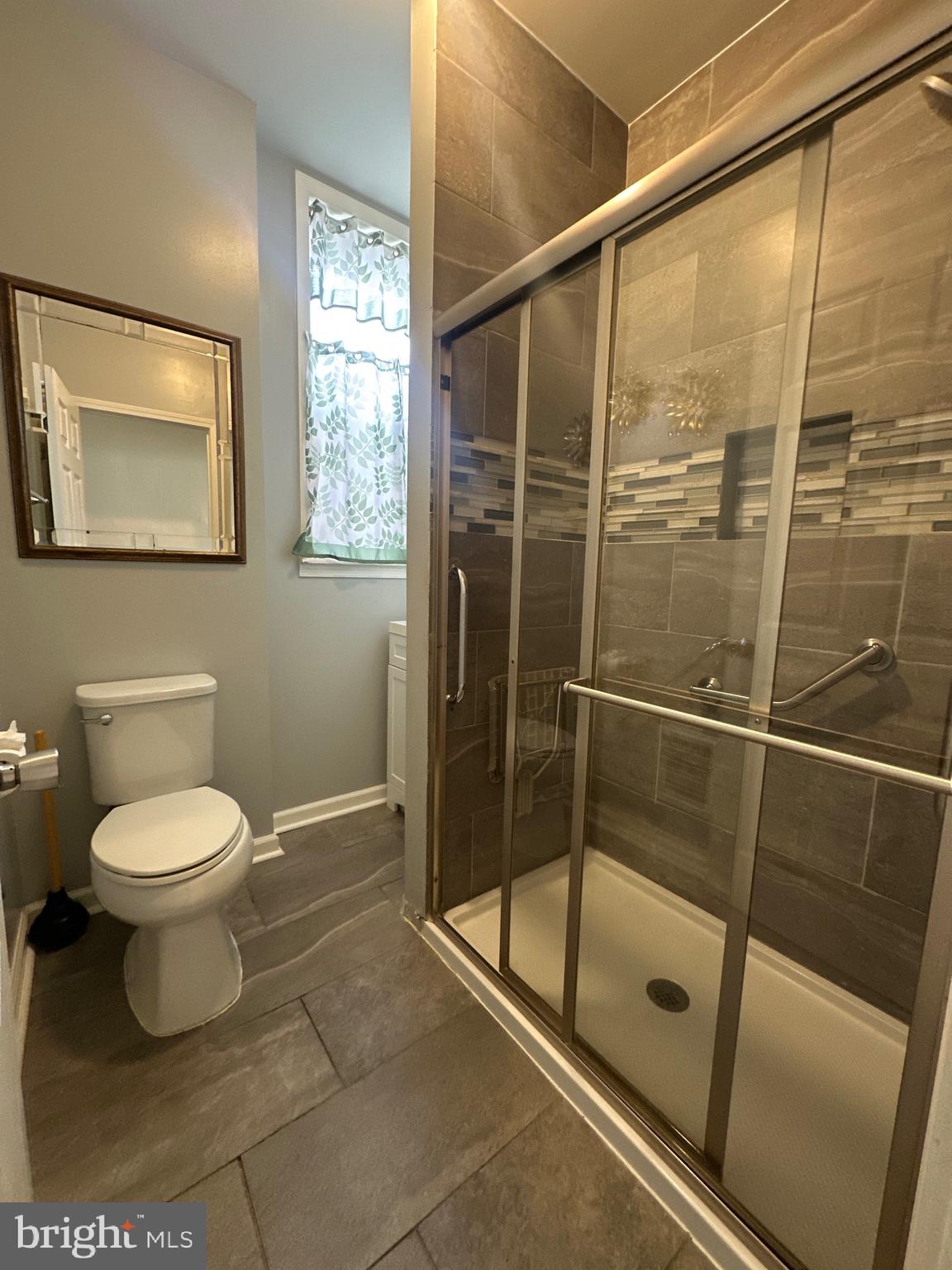 5403 Webster Street Philadelphia, PA 19143 - Photo 16 of 25 a bathroom with a toilet and a shower