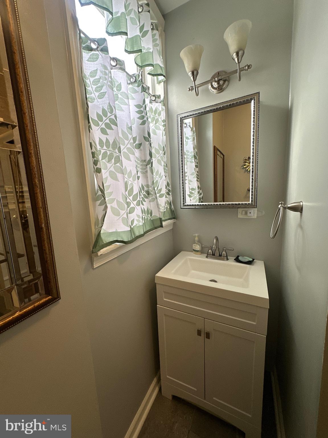 5403 Webster Street Philadelphia, PA 19143 - Photo 17 of 25 a bathroom with a toilet sink and mirror