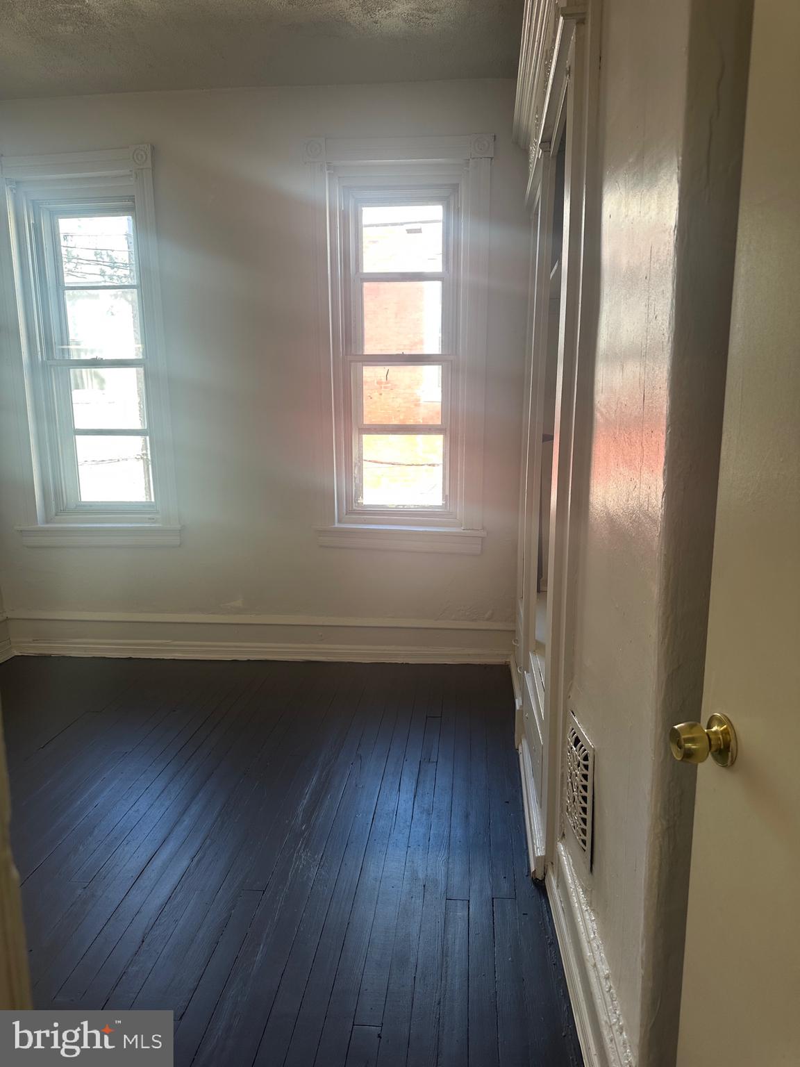 5403 Webster Street Philadelphia, PA 19143 - Photo 19 of 25 a view of an empty room with wooden floor and a window