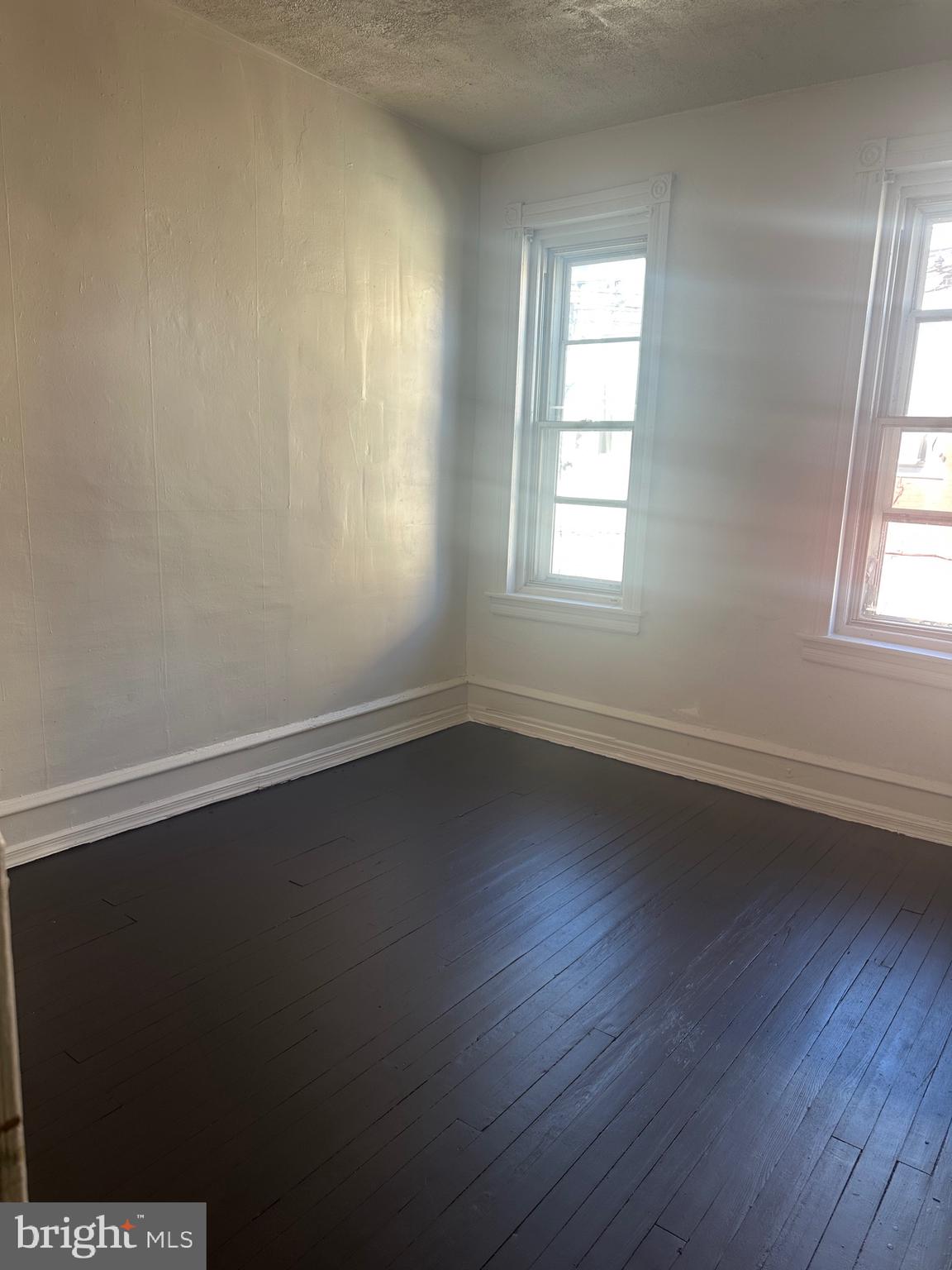 5403 Webster Street Philadelphia, PA 19143 - Photo 20 of 25 an empty room with wooden floor and windows