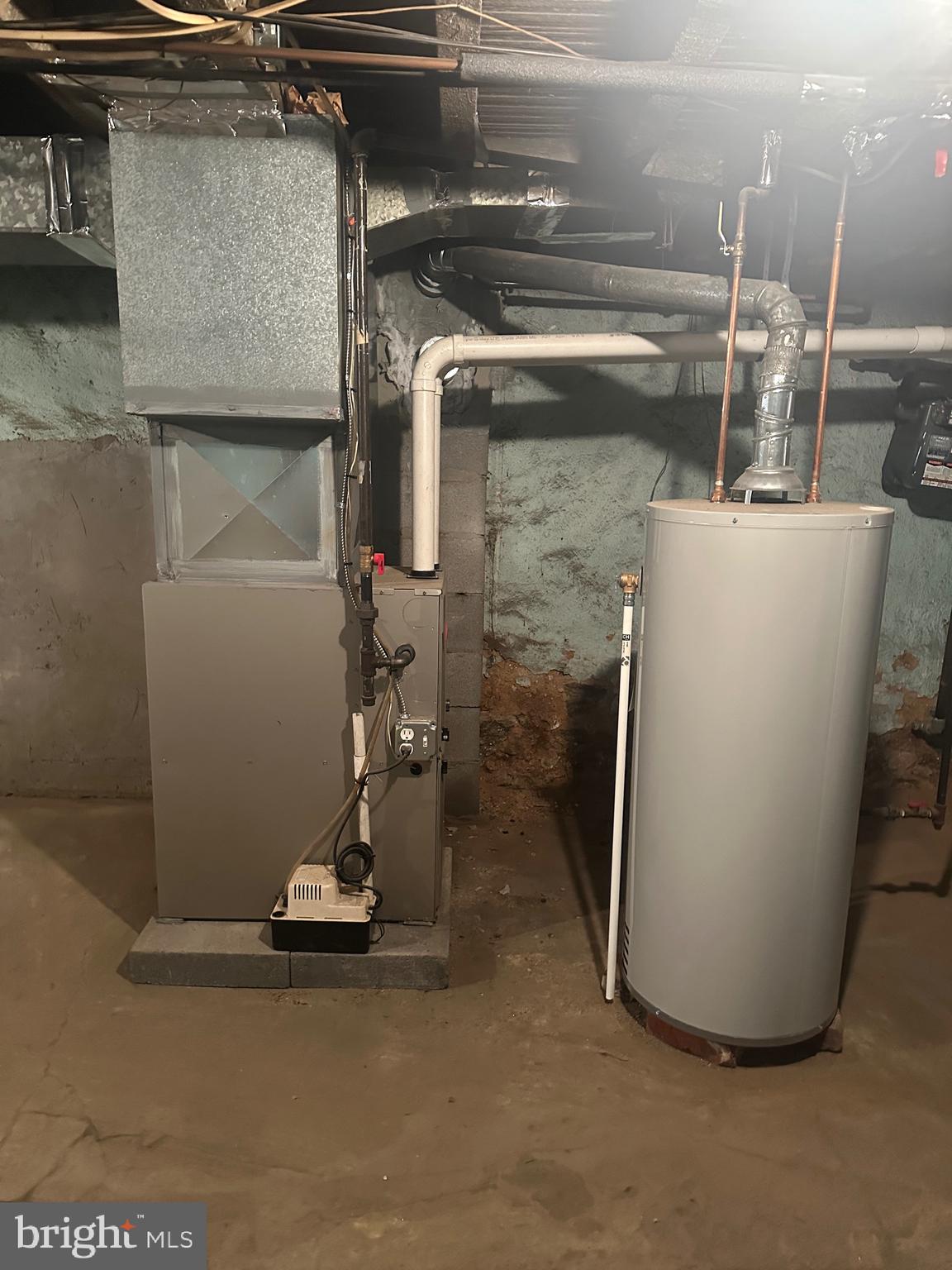 5403 Webster Street Philadelphia, PA 19143 - Photo 24 of 25 a room with water heater and wooden cabinets