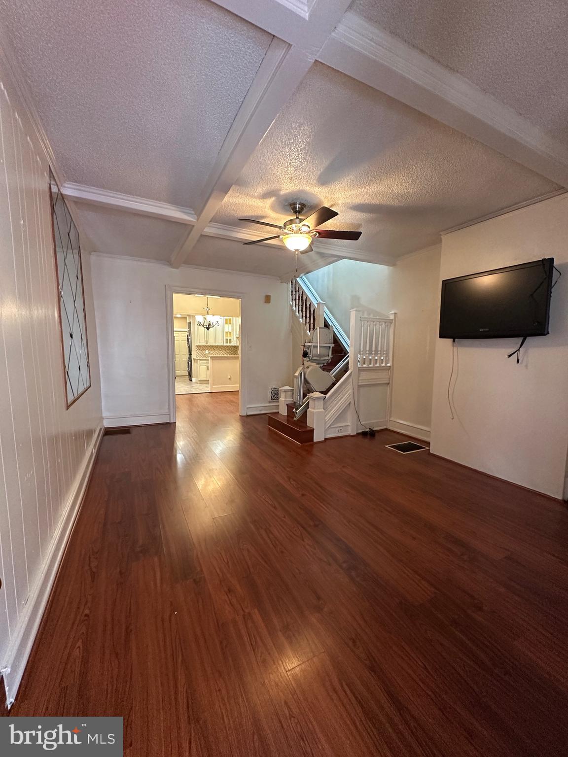 5403 Webster Street Philadelphia, PA 19143 - Photo 4 of 25 a view of a room with wooden floor staircase and a kitchen