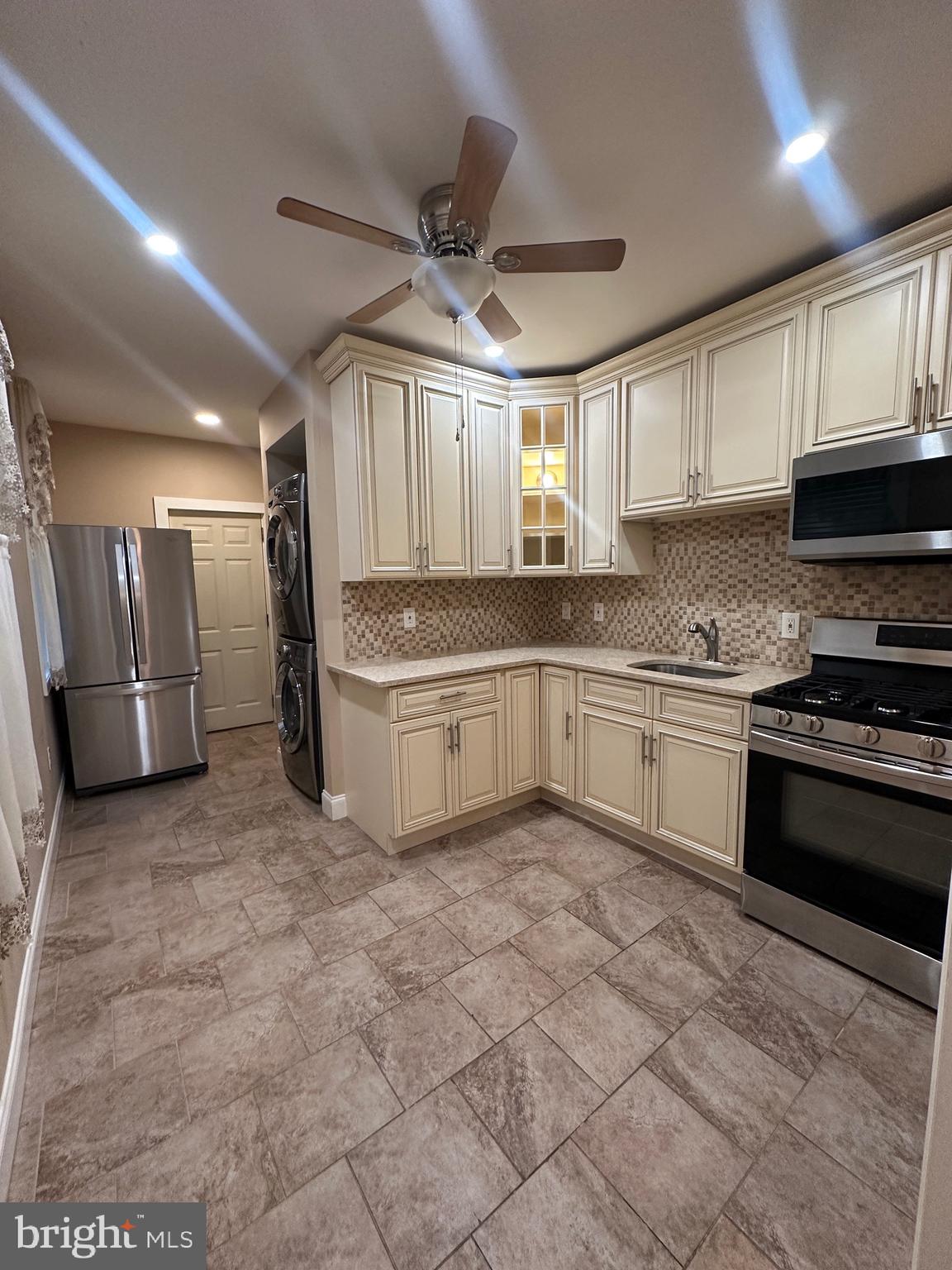 5403 Webster Street Philadelphia, PA 19143 - Photo 8 of 25 a kitchen with stainless steel appliances granite countertop a stove sink and cabinets