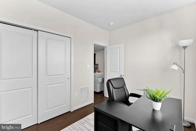 a view of a workspace with furniture and wooden floor