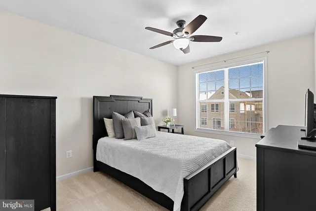 a bedroom with a large bed and a large window