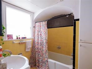 1849 West Main Street, Unit 2 Houston, TX 77098 - Photo 7 of 9 Adorable yellow vintage tile adds a uniquely cheerful charm and timeless character to the bathroom.