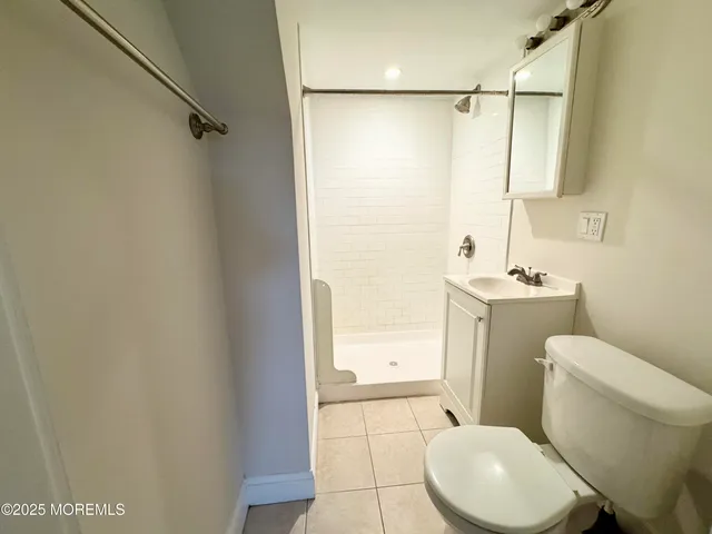 a white toilet sitting next to a bathroom sink