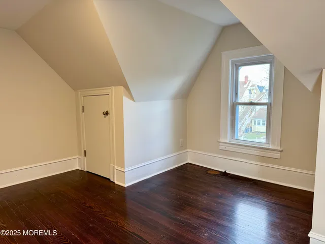 a view of a livingroom with wooden floor and window