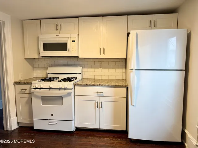 a white refrigerator freezer sitting in a kitchen