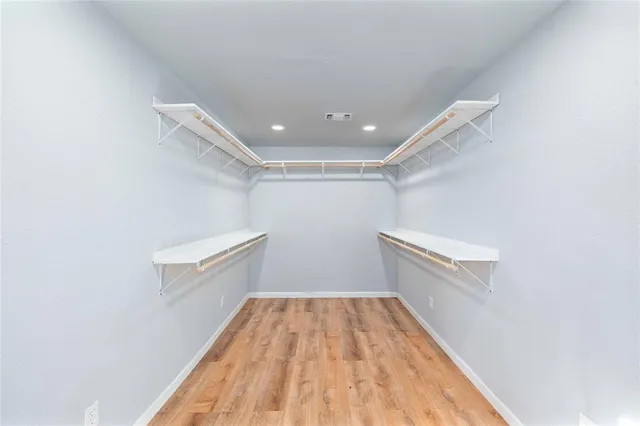 a spacious bathroom with a granite countertop sink a toilet and shower