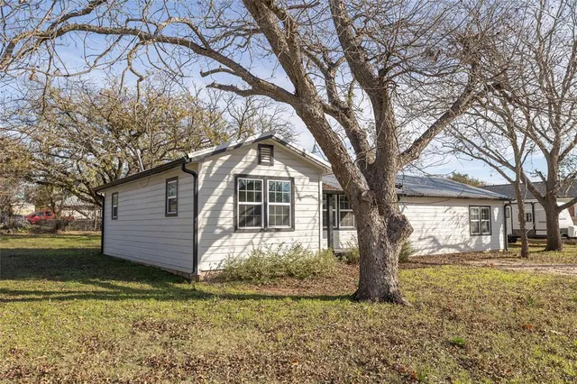 a big house with trees in front of it