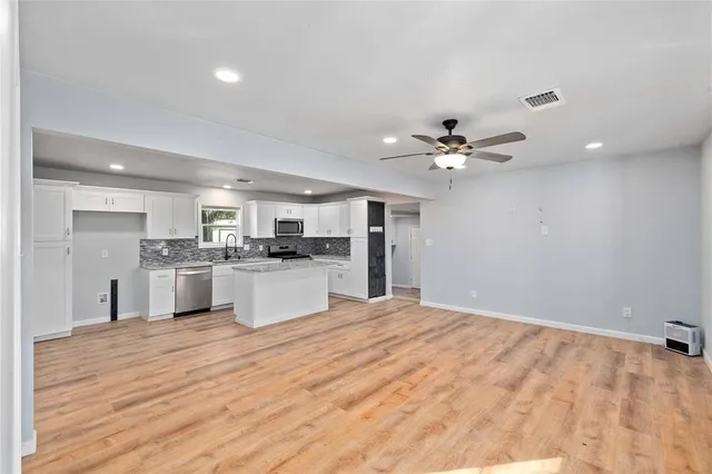 a view of kitchen with cabinets