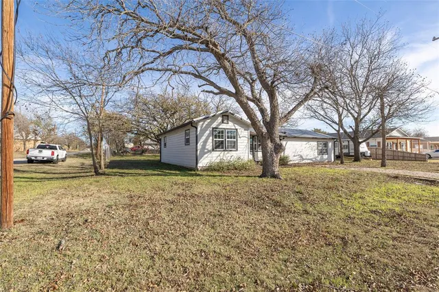 a view of a house with a snow in the yard