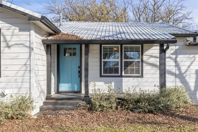 a view of a house with a large window and a yard