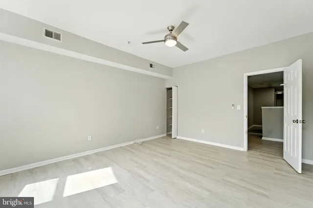 a view of empty room with wooden floor