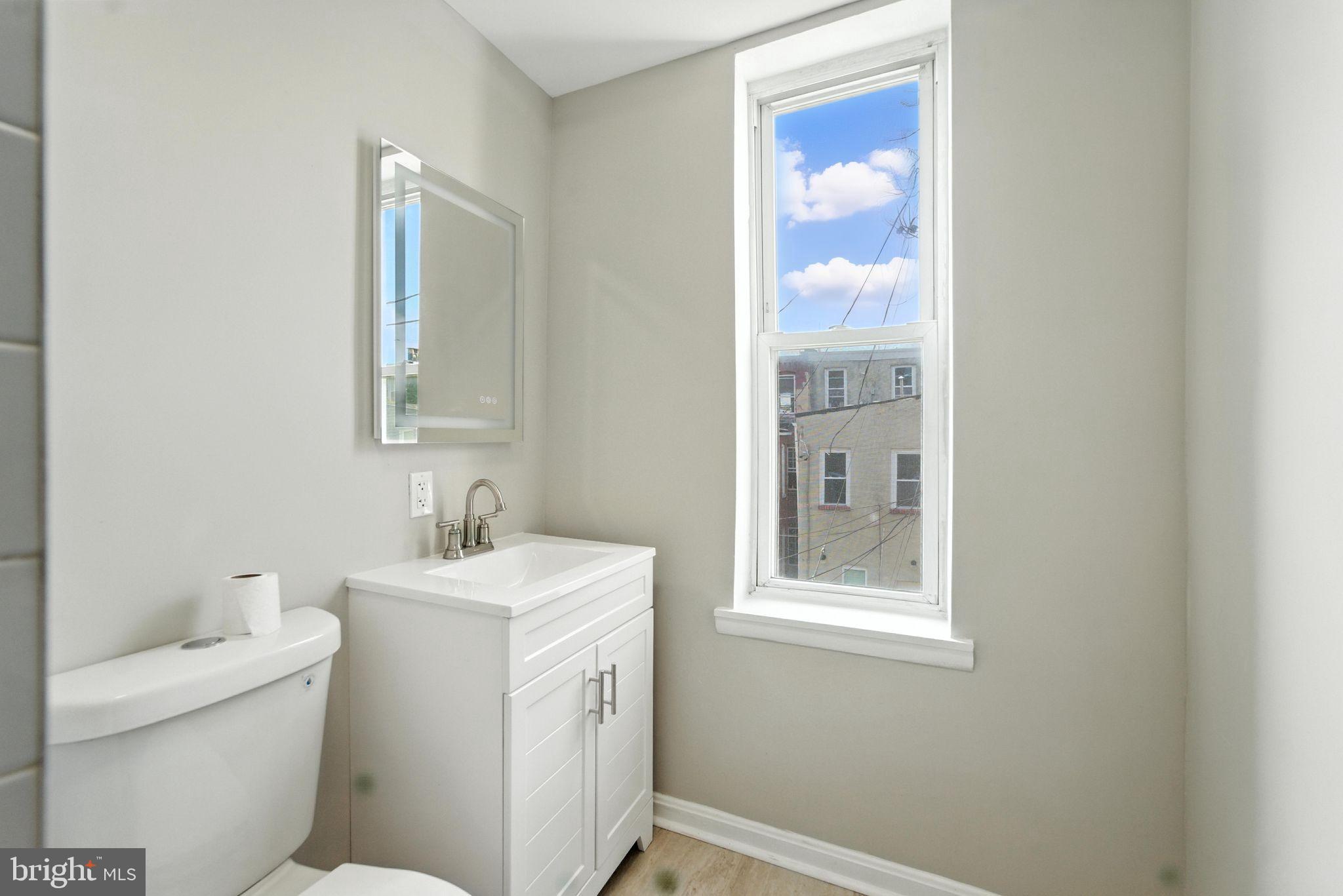 2100 Homewood Avenue, Unit 2 Baltimore, MD 21218 - Photo 6 of 10 a bathroom with a sink and a toilet