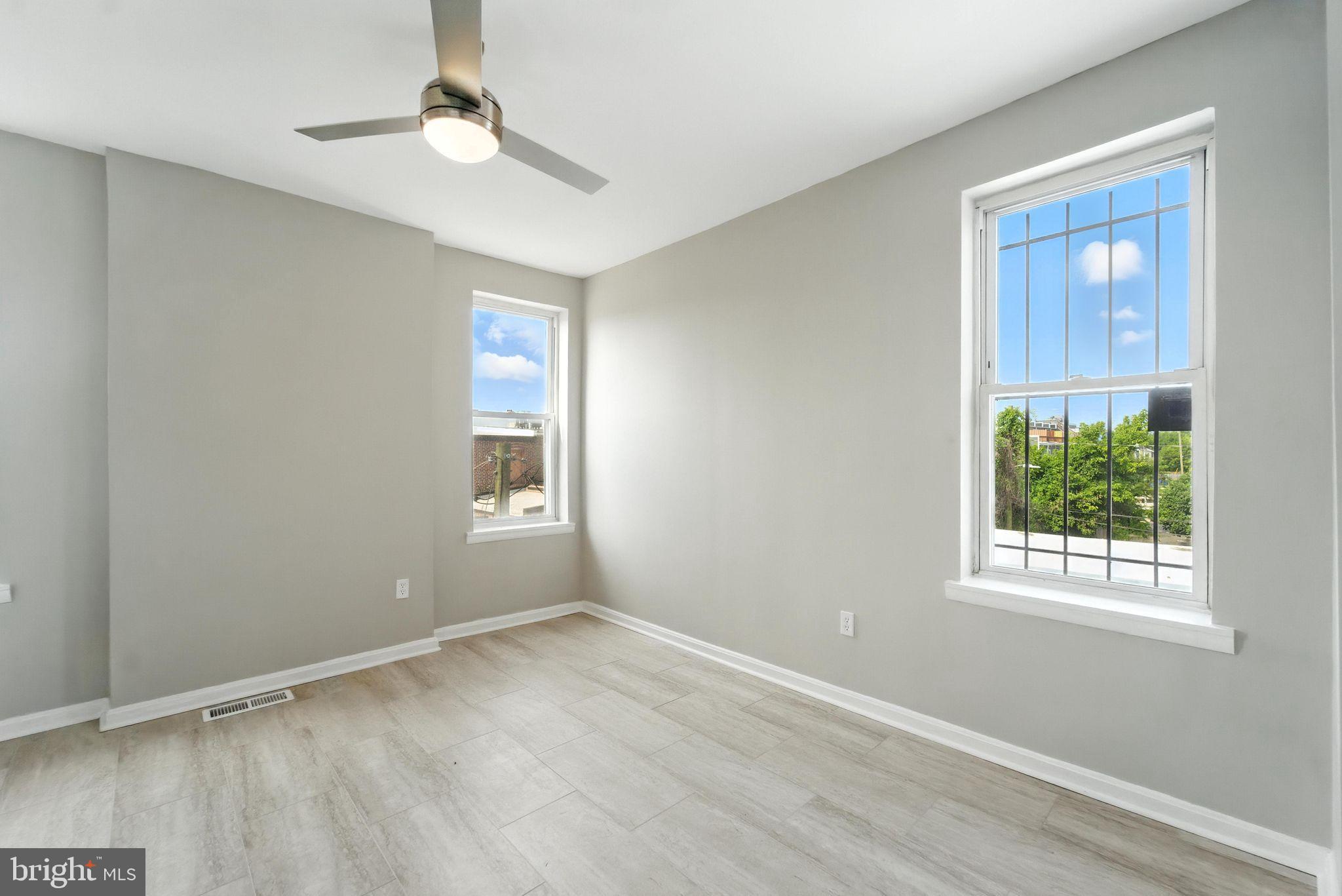 2100 Homewood Avenue, Unit 2 Baltimore, MD 21218 - Photo 8 of 10 a view of an empty room with wooden floor and a window