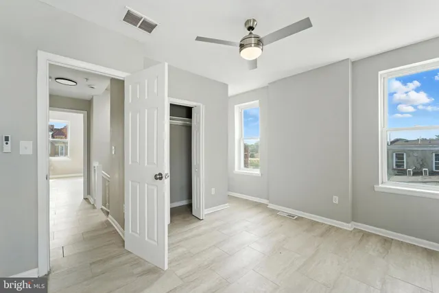 wooden floor in an empty room with a window