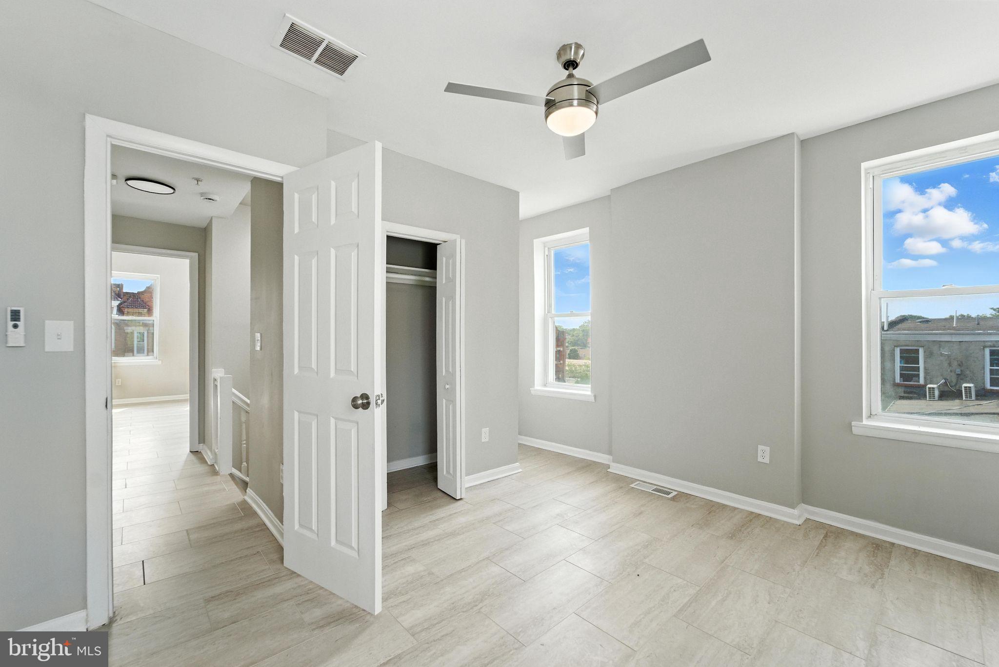 2100 Homewood Avenue, Unit 2 Baltimore, MD 21218 - Photo 9 of 10 wooden floor in an empty room with a window
