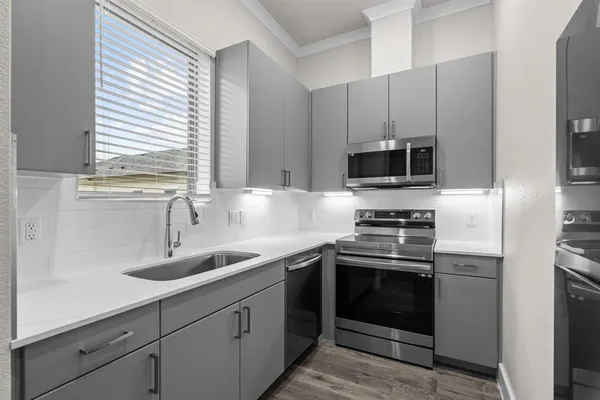 a kitchen with appliances cabinets and a sink