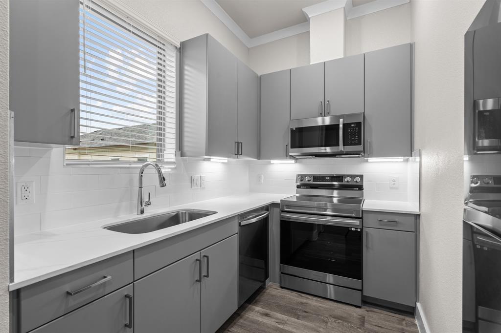 a kitchen with appliances cabinets and a sink