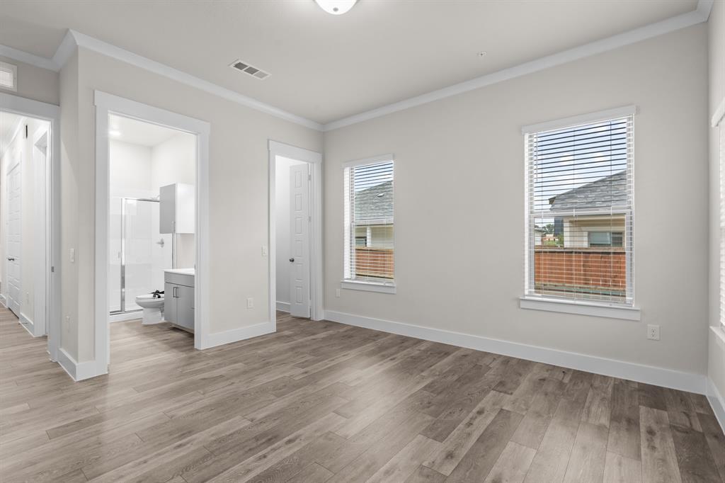 3280 Ganzer Road West, Unit 127B Denton, TX 76207 - Photo 13 of 22 a view of an empty room with wooden floor and a window