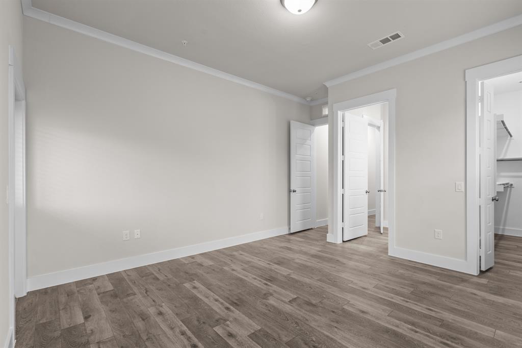 3280 Ganzer Road West, Unit 127B Denton, TX 76207 - Photo 14 of 22 a view of an empty room and wooden floor