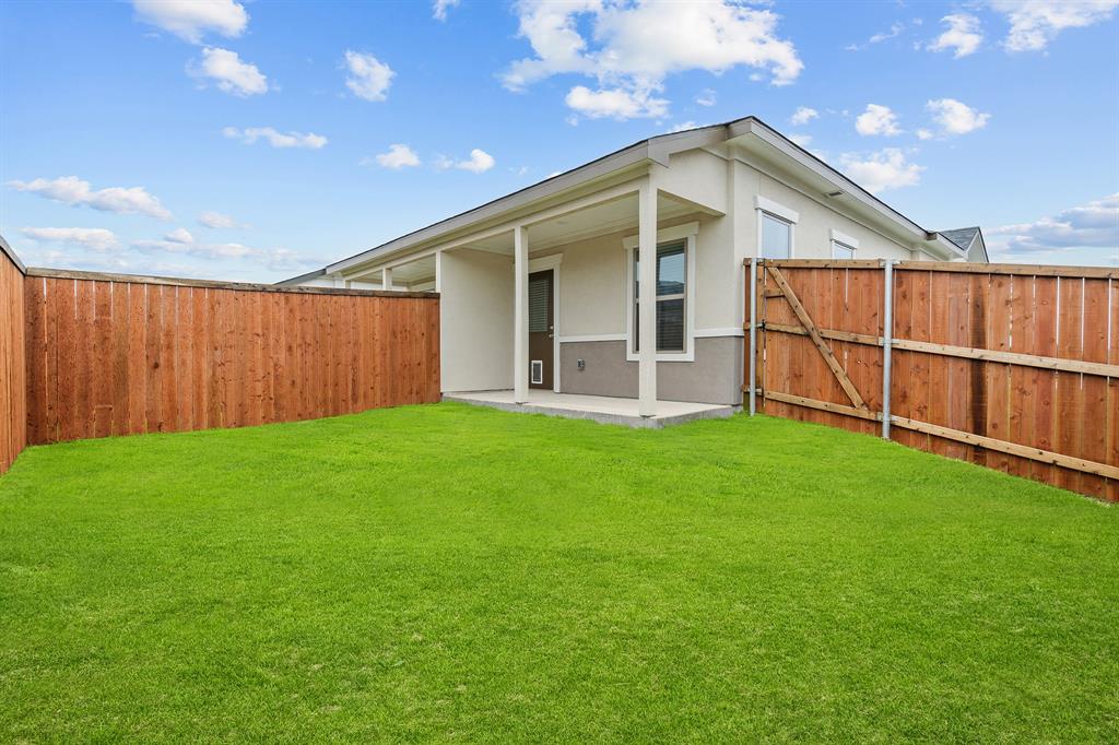 3280 Ganzer Road West, Unit 127B Denton, TX 76207 - Photo 21 of 22 a view of a backyard with plants and large tree