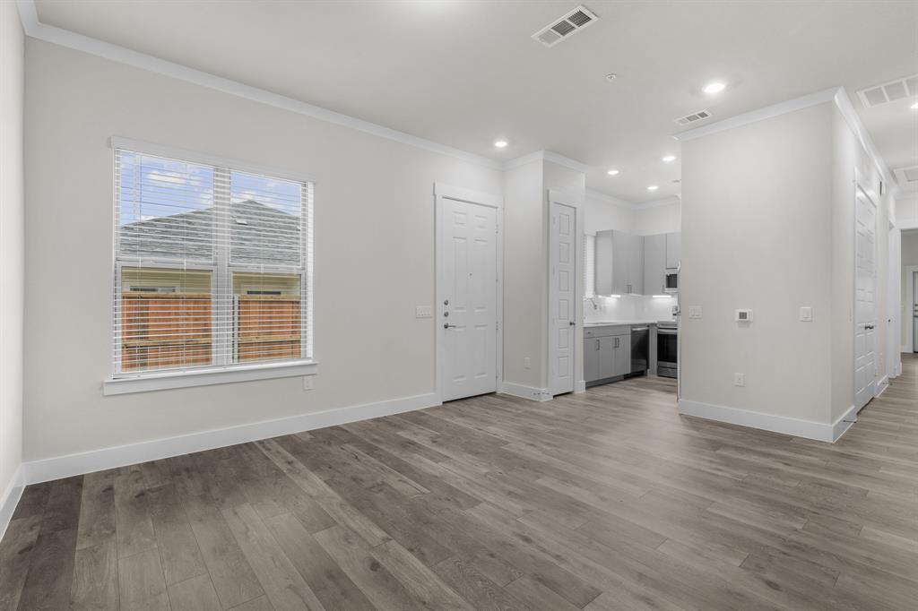 3280 Ganzer Road West, Unit 127B Denton, TX 76207 - Photo 5 of 22 an empty room with wooden floor and windows