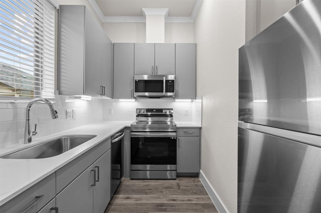 3280 Ganzer Road West, Unit 127B Denton, TX 76207 - Photo 8 of 22 a kitchen with a sink stove and refrigerator